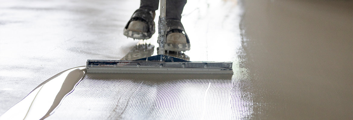 BNE staff taking care to prepare a floor before adding a final polyurethane coating